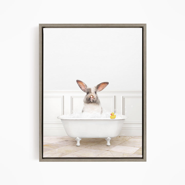 A white rabbit sitting in a white bathtub filled with bubbles, with a rubber duck floating in the water.