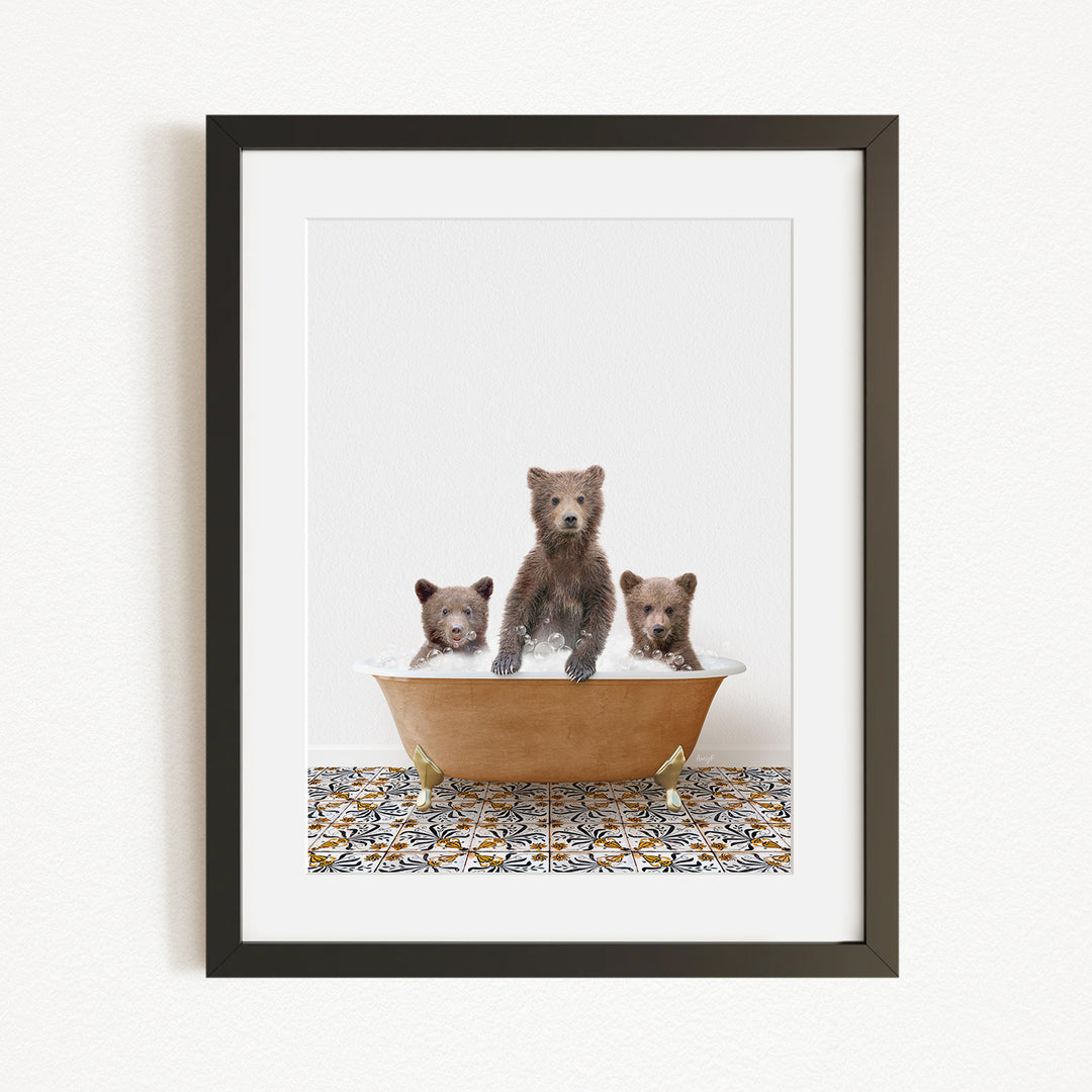 A framed image depicting three bears sitting in a bathtub filled with water, with one bear standing and the other two sitting.