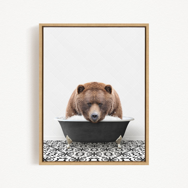 A brown bear is sitting in a black bathtub filled with water, appearing to enjoy a relaxing bath.