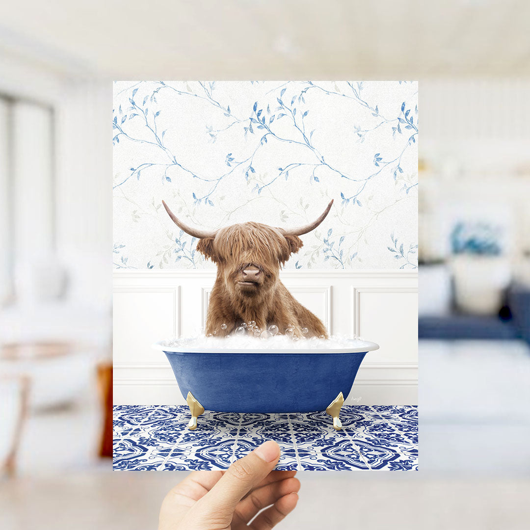 A brown cow with horns is sitting in a blue bathtub filled with water, surrounded by a blue and white floral patterned wall.