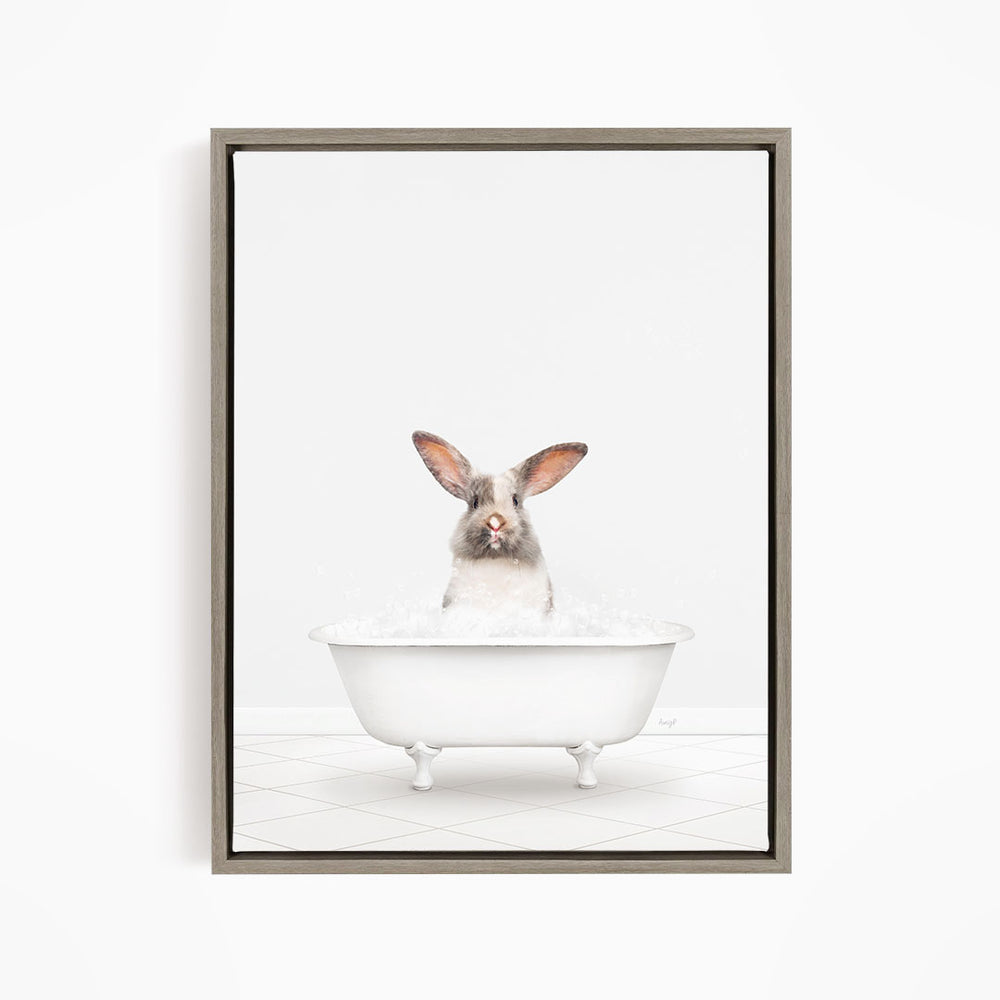 A white rabbit sitting in a white bathtub filled with water, looking up at the camera.