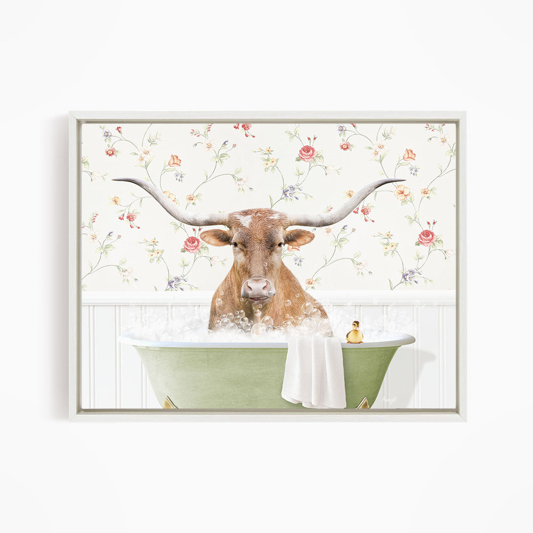 A brown cow with large horns is sitting in a green bathtub filled with water, surrounded by a floral wallpaper.