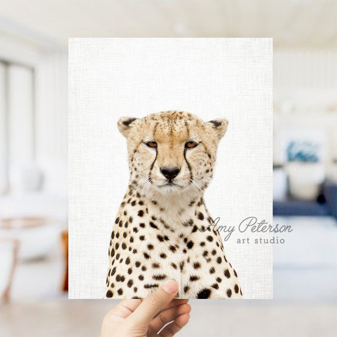 a hand holding a card with a picture of a cheetah