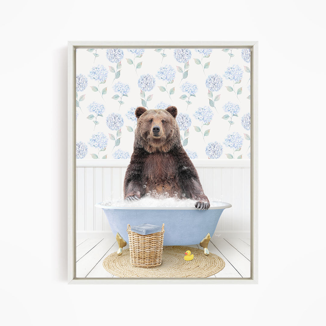 A brown bear sitting in a blue bathtub filled with water, surrounded by a wicker basket and a yellow rubber duck.