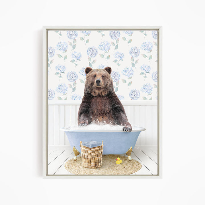 A brown bear sitting in a blue bathtub filled with water, surrounded by a wicker basket and a yellow rubber duck.