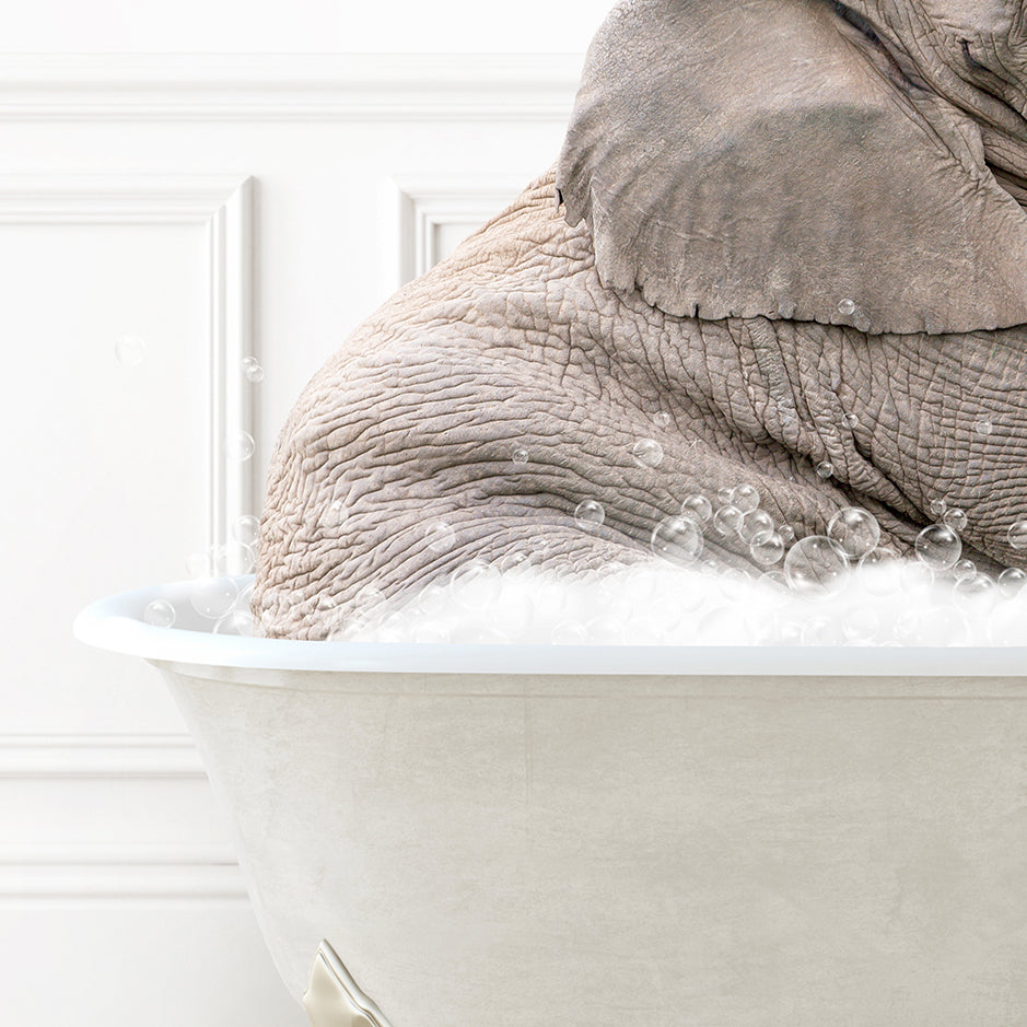 an elephant is taking a bath in a bathtub