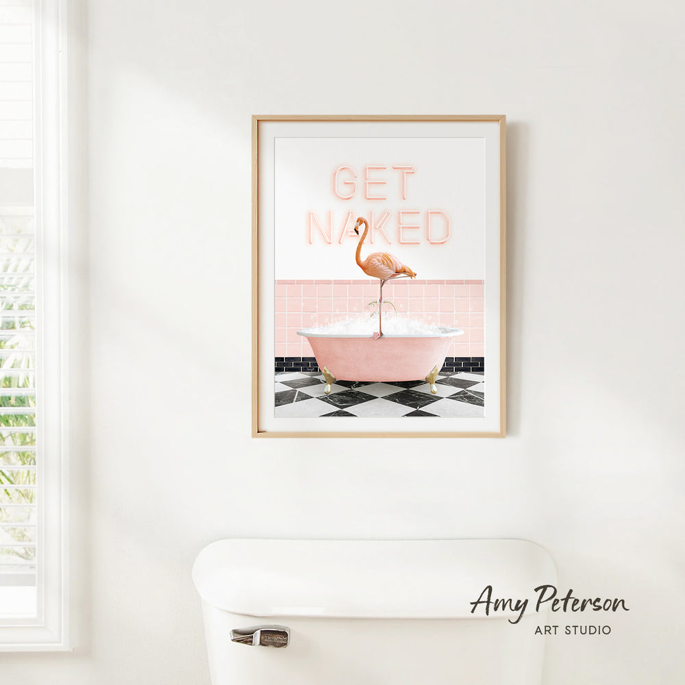 a framed print of a pink flamingo standing in a pink bathtub, with the text "GET NAKED" displayed above it.