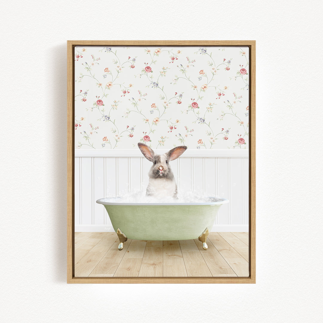 A white rabbit sitting in a green bathtub filled with water, with a floral wallpaper in the background.