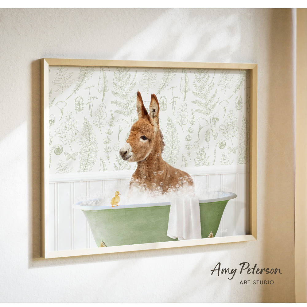 A donkey is sitting in a green bathtub, surrounded by bubbles, with a small yellow duck nearby.