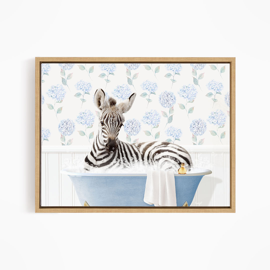 A zebra is sitting in a blue bathtub, surrounded by a floral patterned wall.