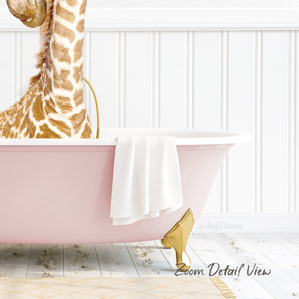 A giraffe is sitting in a pink bathtub, with a white towel and gold bathtub stopper visible.