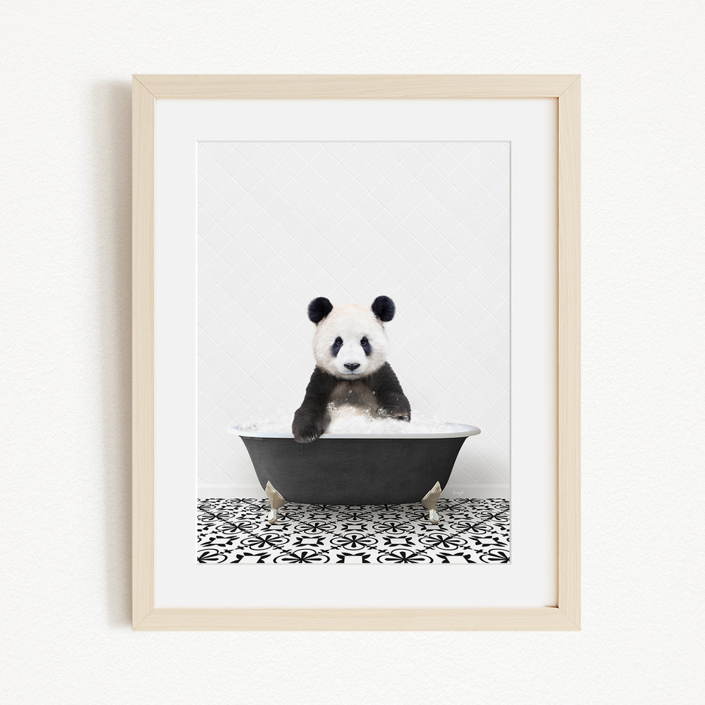 A panda bear sitting in a bathtub, surrounded by a black and white patterned floor.