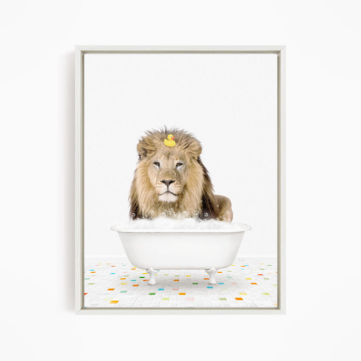 A lion is sitting in a white bathtub filled with bubbles, with a yellow rubber duck floating on its head.