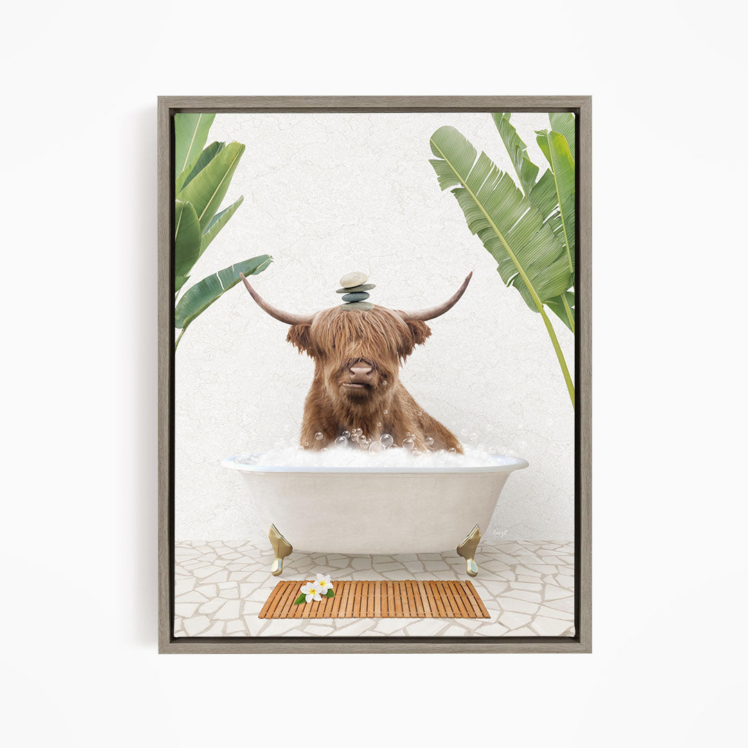 A brown cow with horns is sitting in a white bathtub filled with water, surrounded by tropical plants and a wooden mat on the floor.