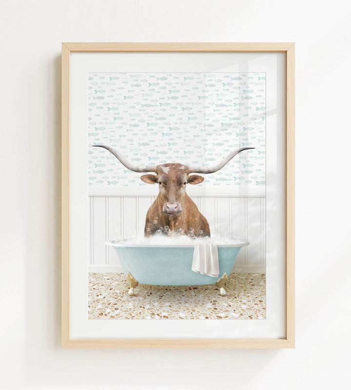 A picture of a horned animal, possibly a cow or a bull, sitting in a blue bathtub filled with bubbles.