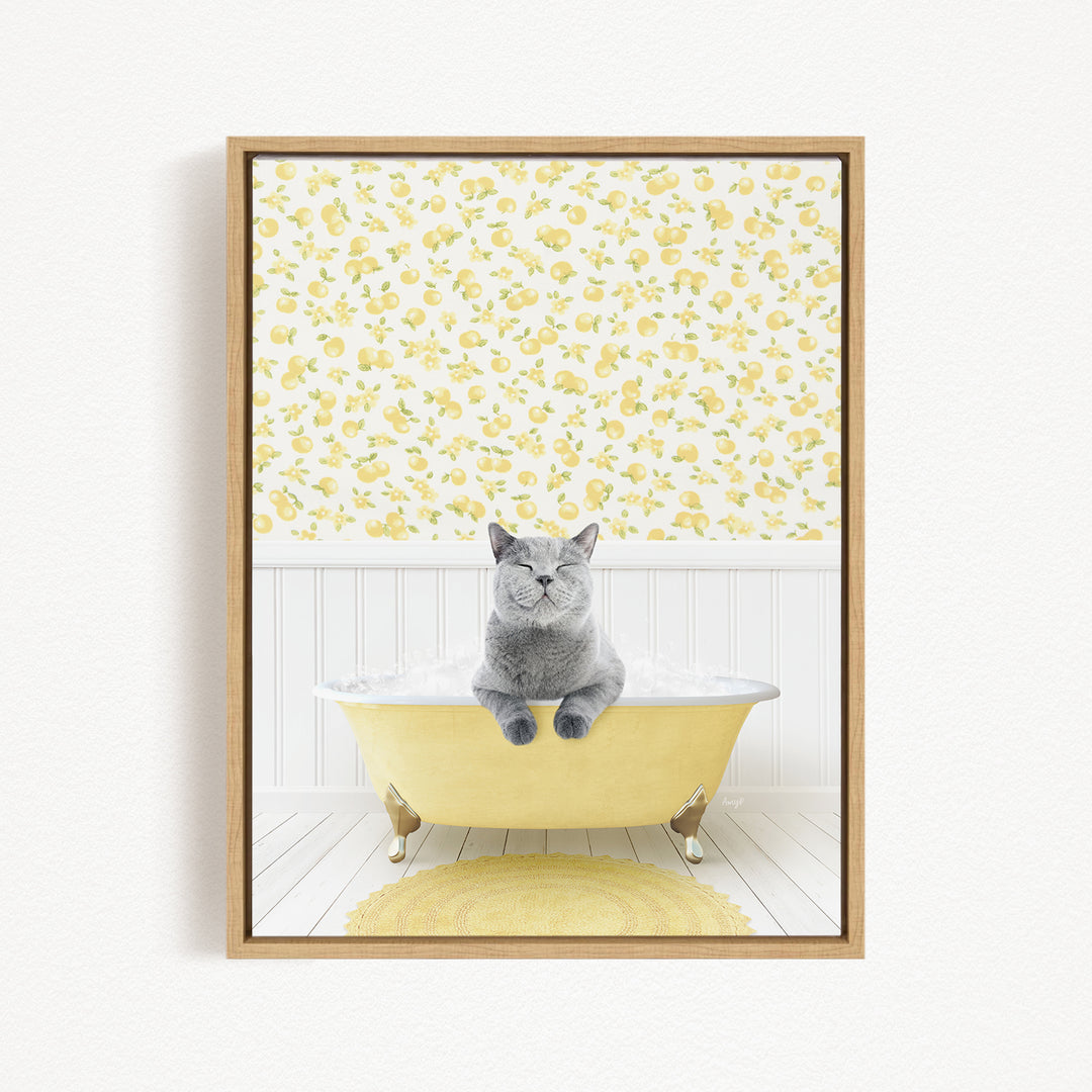 A gray cat sitting in a yellow bathtub, surrounded by a yellow floral pattern on the wall behind it.
