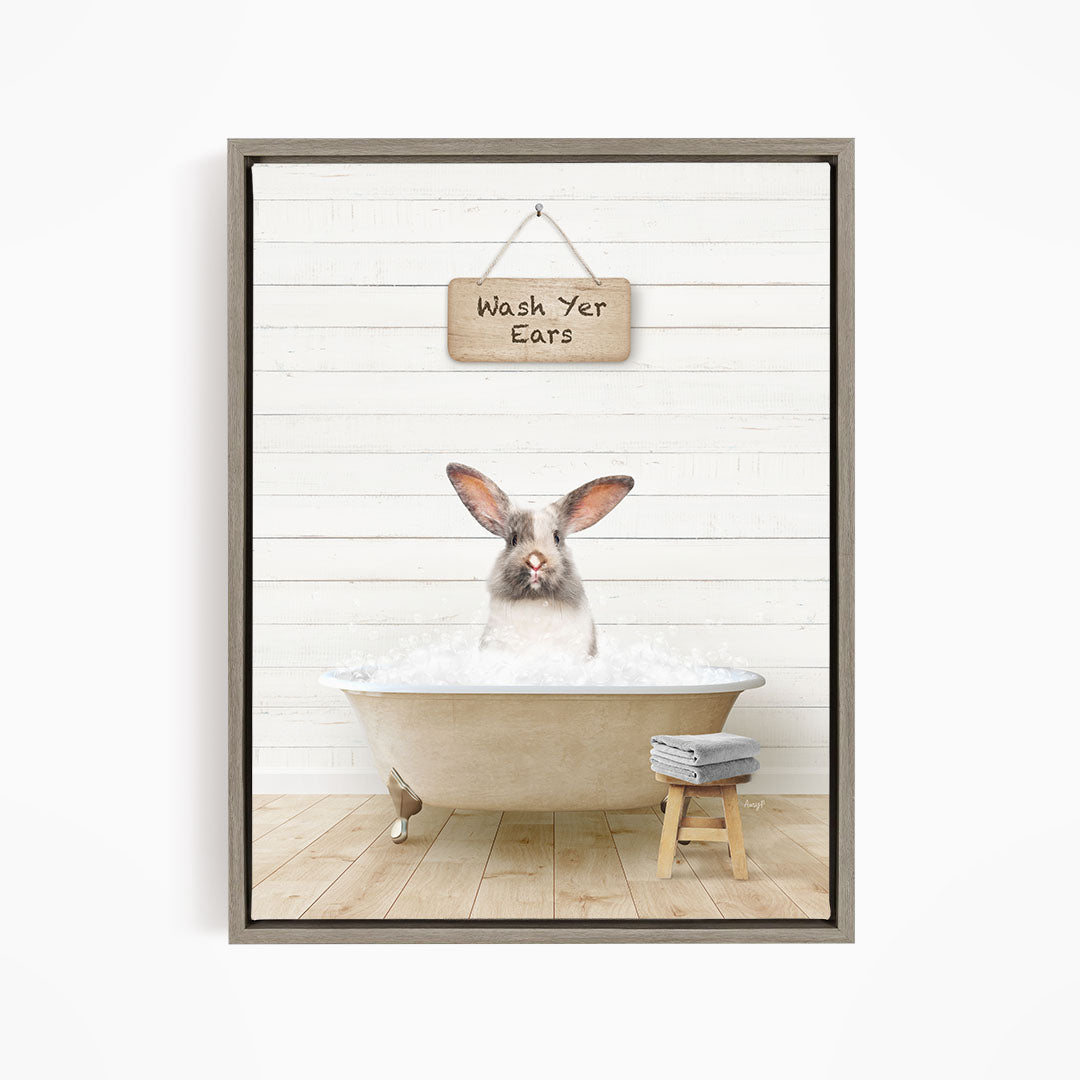 A white rabbit sitting in a bathtub, with a wooden sign above that says "Wash Your Ears".