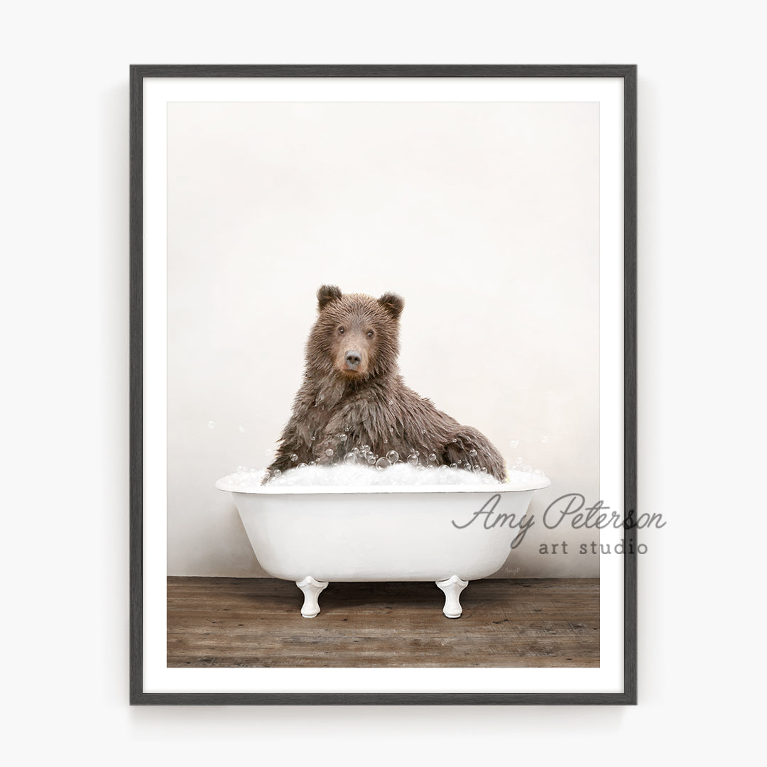 a brown bear sitting in a bath tub