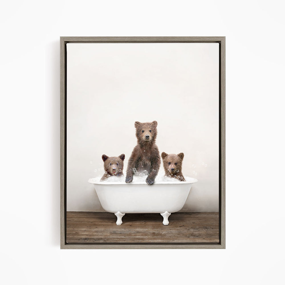 Three adorable brown bears sitting in a white bathtub, enjoying a relaxing bath together.