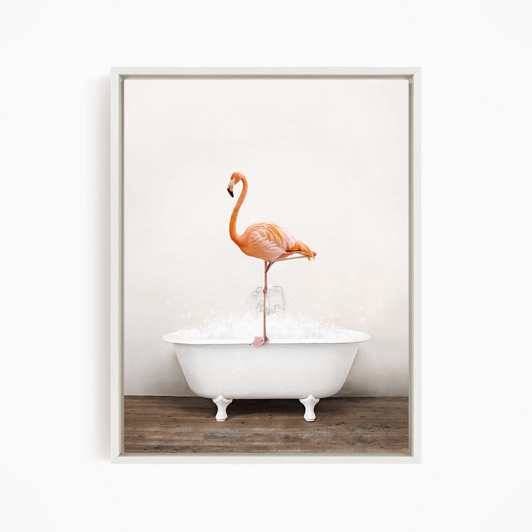 A vibrant orange flamingo stands on the edge of a white bathtub filled with water, creating a whimsical and playful scene.
