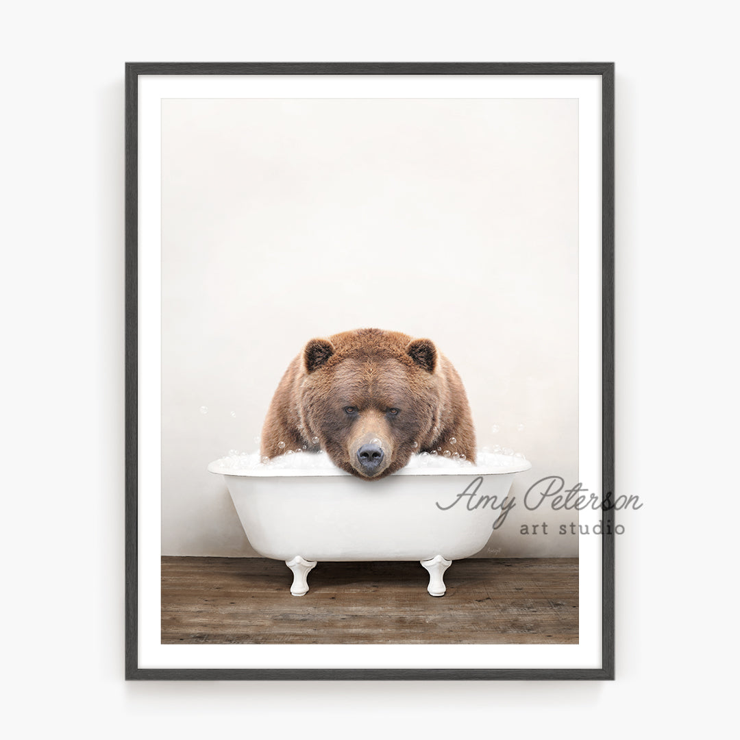 a brown bear is taking a bath in a bathtub