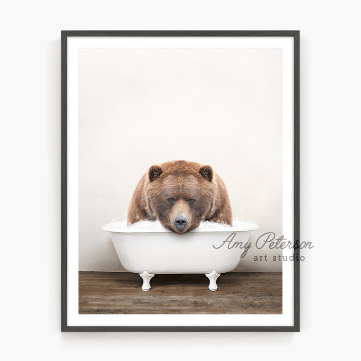 a brown bear is taking a bath in a bathtub