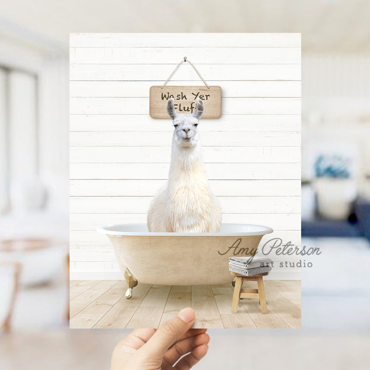 a llama sitting in a bathtub with a sign hanging from it's