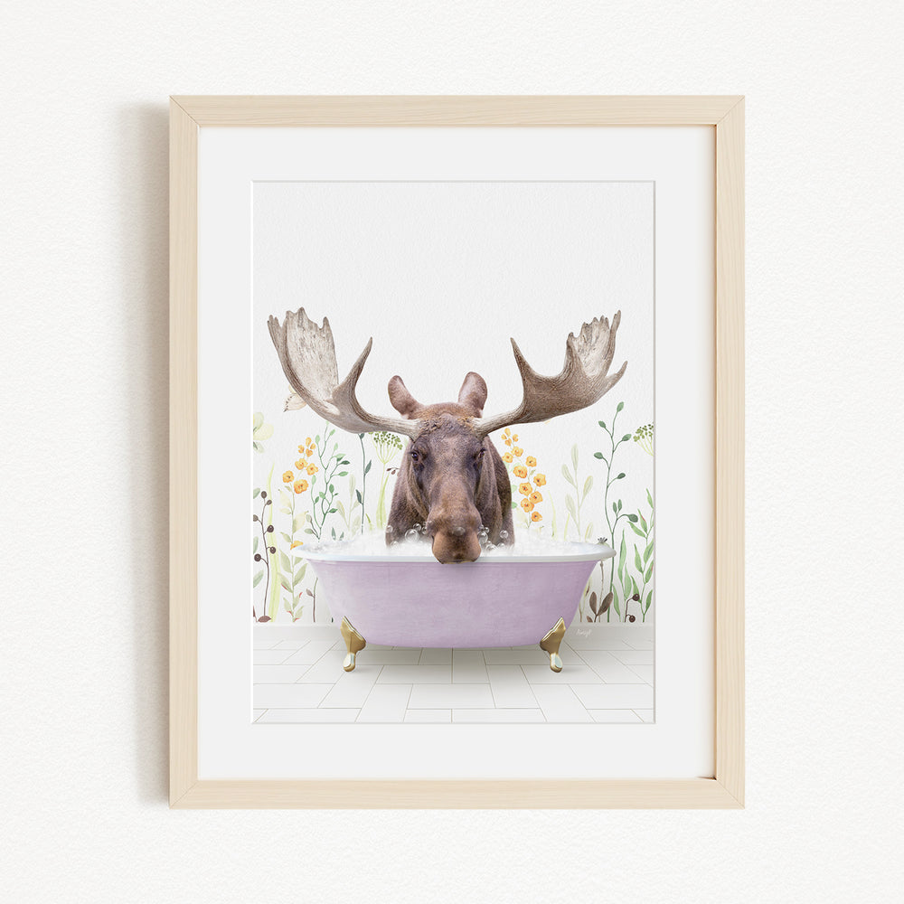 A moose with large antlers is sitting in a purple bathtub, surrounded by flowers and plants.