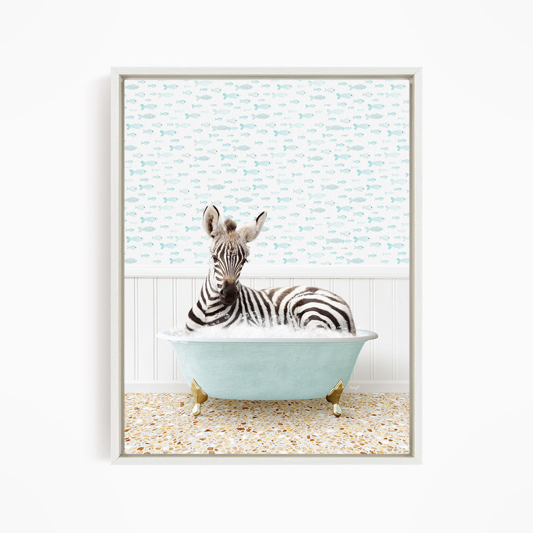 A zebra is sitting in a light blue bathtub, surrounded by a pattern of small fish.