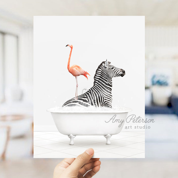 a hand holding a card with a zebra and a flamingo in a bathtub