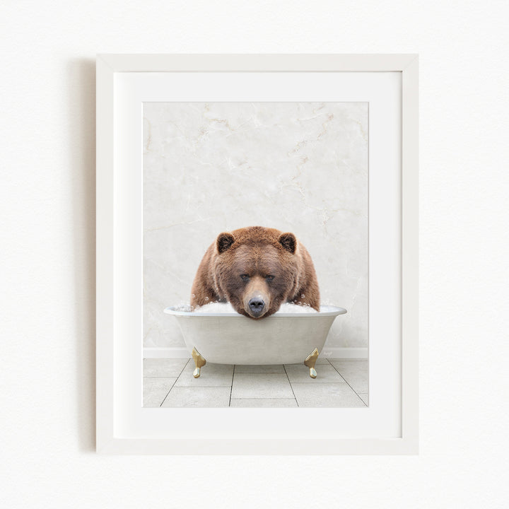 A brown bear is sitting in a white bathtub, appearing to be enjoying a relaxing bath.