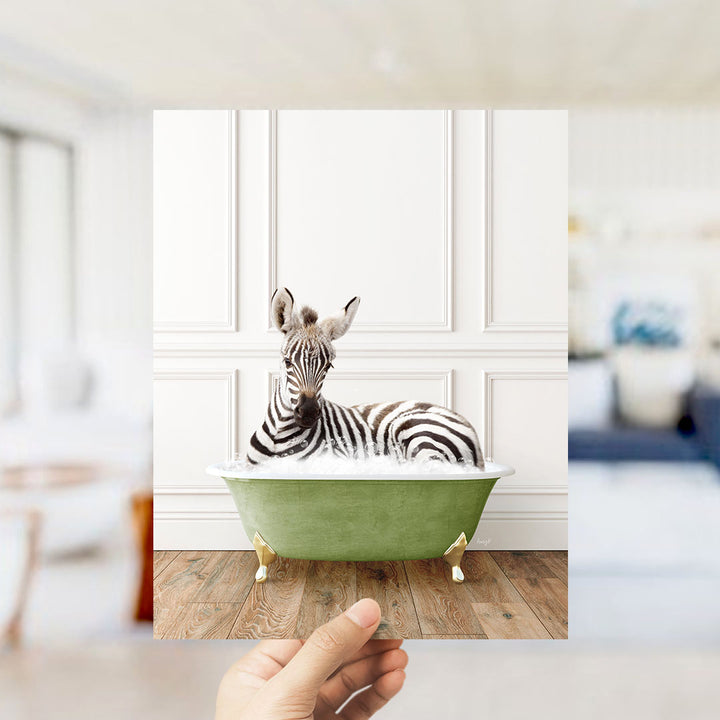 A zebra lying in a green bathtub, surrounded by a blurred background of a living room.