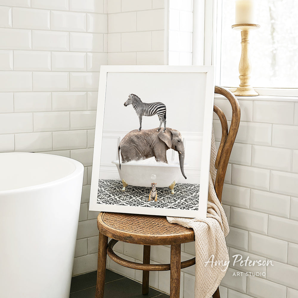 A framed image of a zebra standing on an elephant's back, both in a bathtub, is displayed on a wooden chair in a bathroom setting.