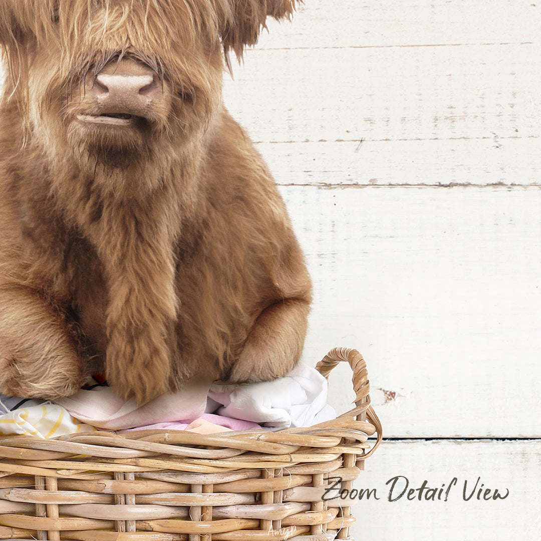A close-up image of a brown furry animal, possibly a dog or a cat, sitting in a wicker basket.