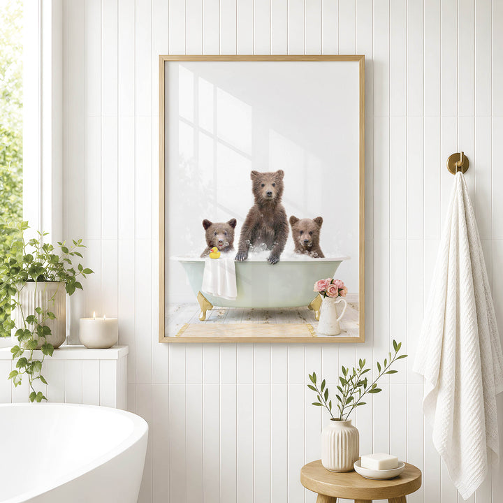 A framed image of three bears sitting in a bathtub, with one bear sitting on the edge of the tub and the other two bears sitting inside the tub.