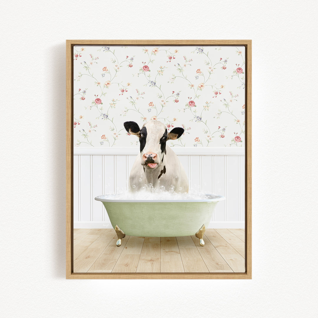 A cow is sitting in a green bathtub filled with water, surrounded by a floral wallpaper.