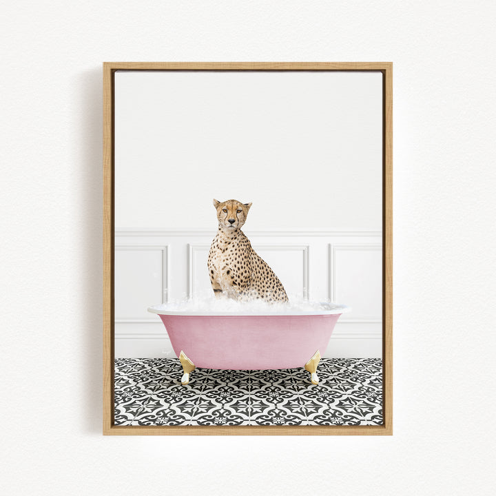 A cheetah sitting in a pink bathtub filled with bubbles, surrounded by a black and white patterned floor.