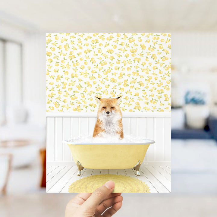 A fox is sitting in a yellow bathtub filled with bubbles, surrounded by a yellow and white floral patterned wall.