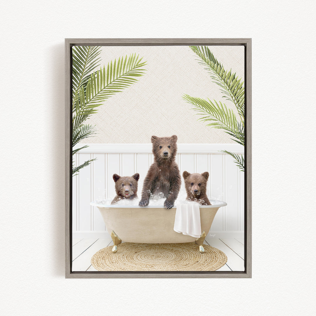 Three adorable brown bears sitting in a bathtub filled with water, surrounded by green palm leaves.