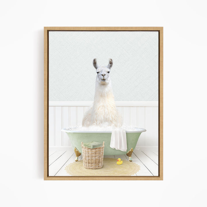 A white llama sitting in a green bathtub filled with bubbles, surrounded by a basket of toys and a yellow rubber duck.