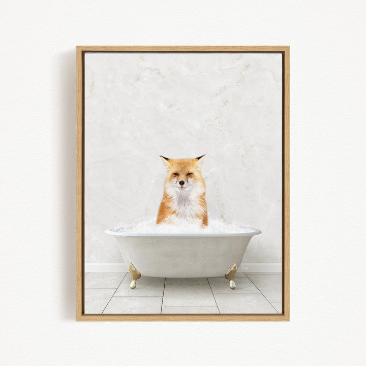 A red fox sitting in a white bathtub filled with bubbles, looking directly at the camera.