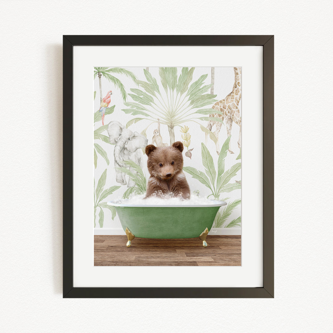 A framed image depicting a small brown bear sitting in a green bathtub, surrounded by a tropical wallpaper with various animals.