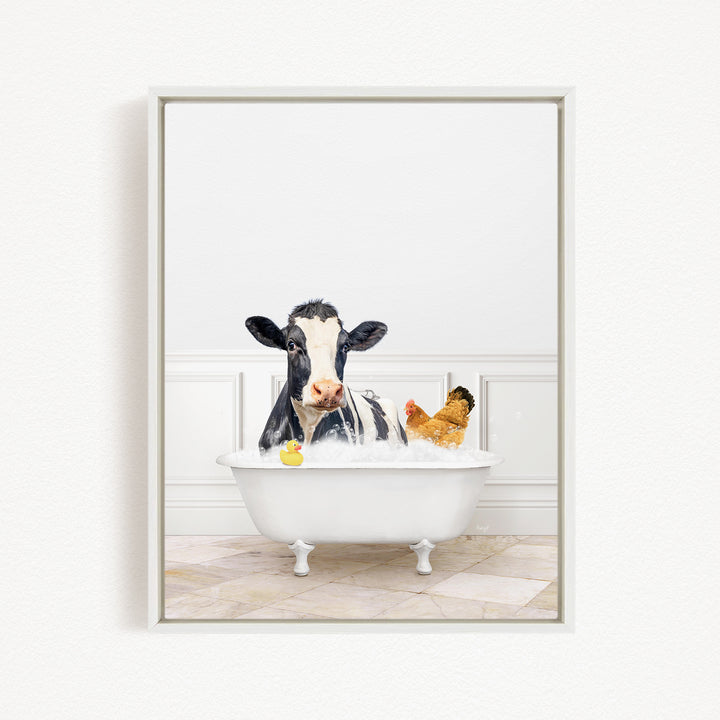 A black and white cow is sitting in a white bathtub filled with water, surrounded by a yellow rubber duck and a chicken.