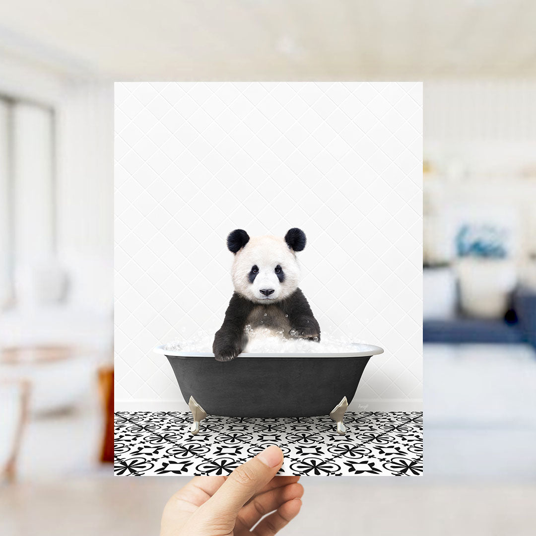 A panda bear sitting in a bathtub filled with bubbles, surrounded by a black and white patterned floor.