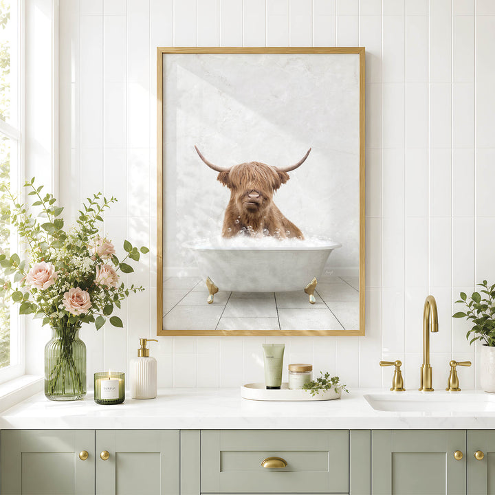 a bathroom with a framed picture of a Highland cow taking a bath in a tub, surrounded by various bathroom accessories and decor.