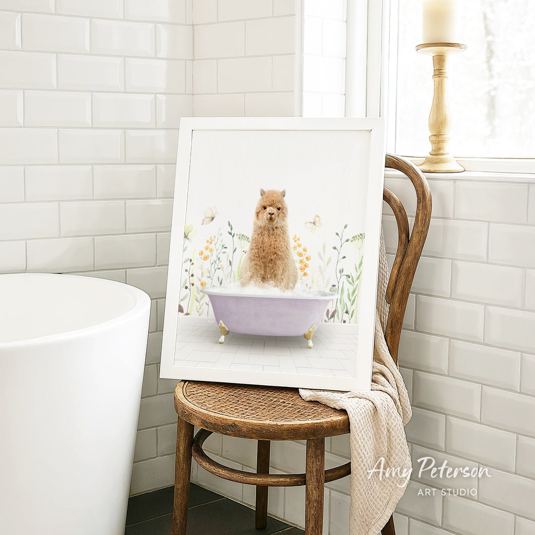 A framed painting of a dog sitting in a bathtub, surrounded by flowers, is displayed on a wooden chair in a bathroom setting.