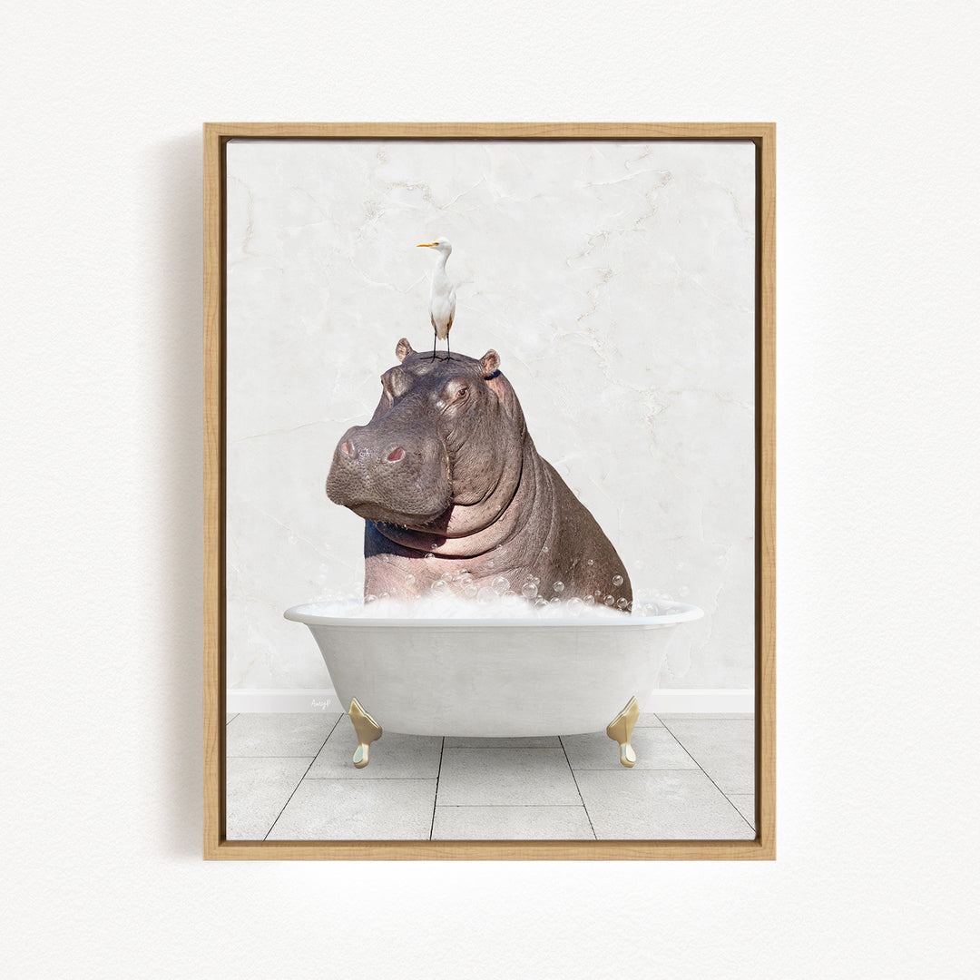 A framed image depicting a hippopotamus sitting in a bathtub, with a bird perched on its head.
