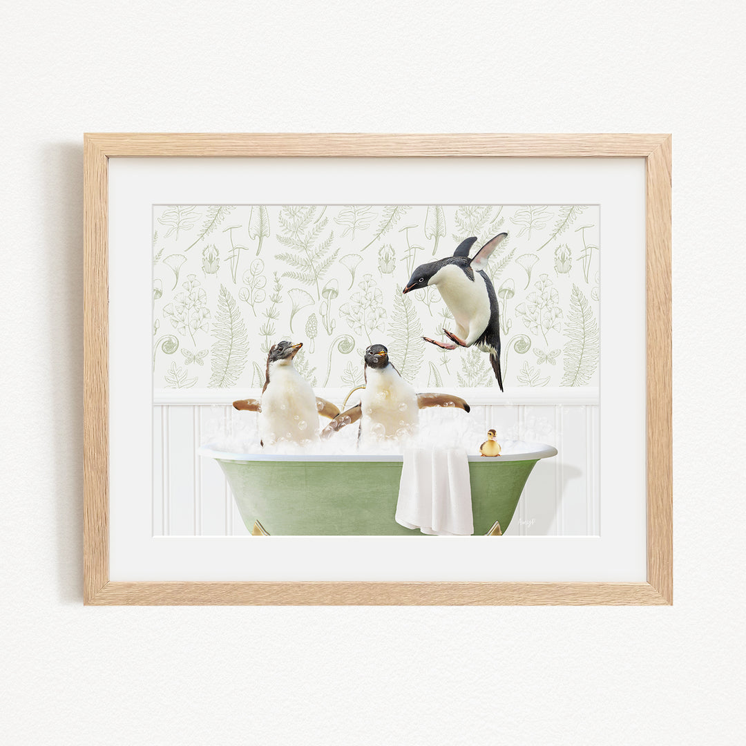 A framed image depicting three penguins sitting in a green bathtub, with one penguin flying towards the others.