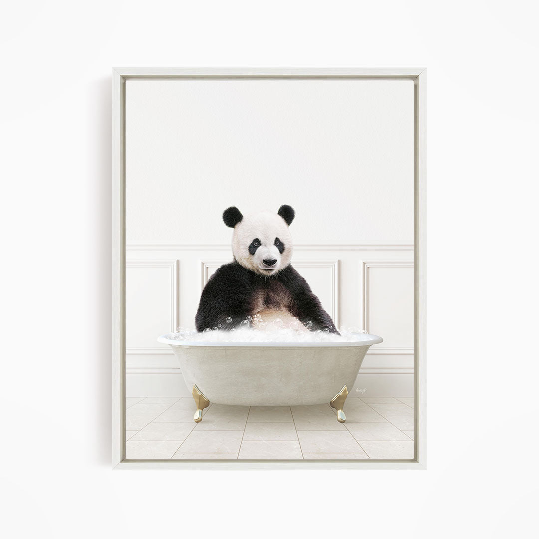A panda bear sitting in a white bathtub filled with bubbles, appearing to enjoy the bath.