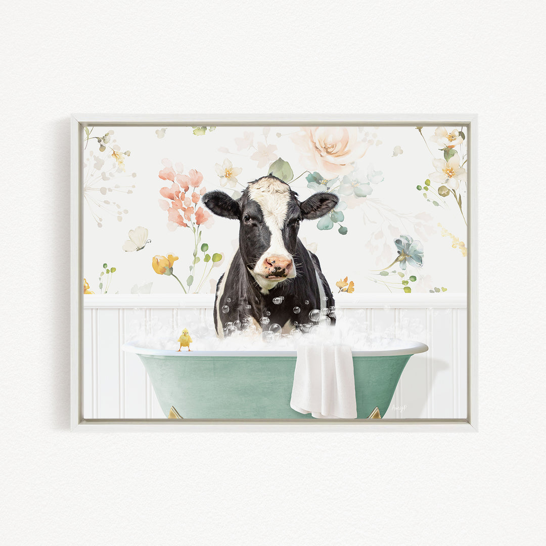 A black and white cow is sitting in a green bathtub filled with bubbles, surrounded by a floral pattern.